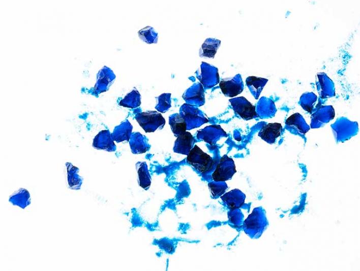 A special type of glass is crushed and ground with a mortar and pestle